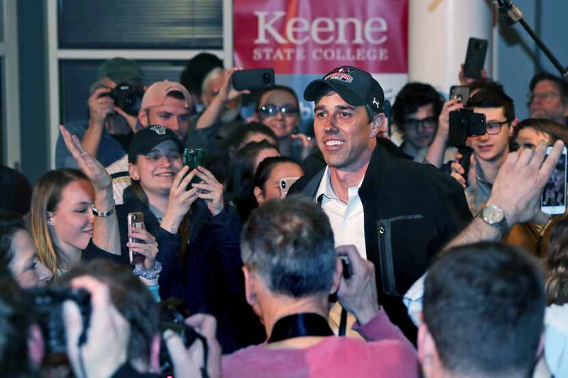 Former Texas congressman Beto O'Rourke smiles as he is surrounded while arriving for a...