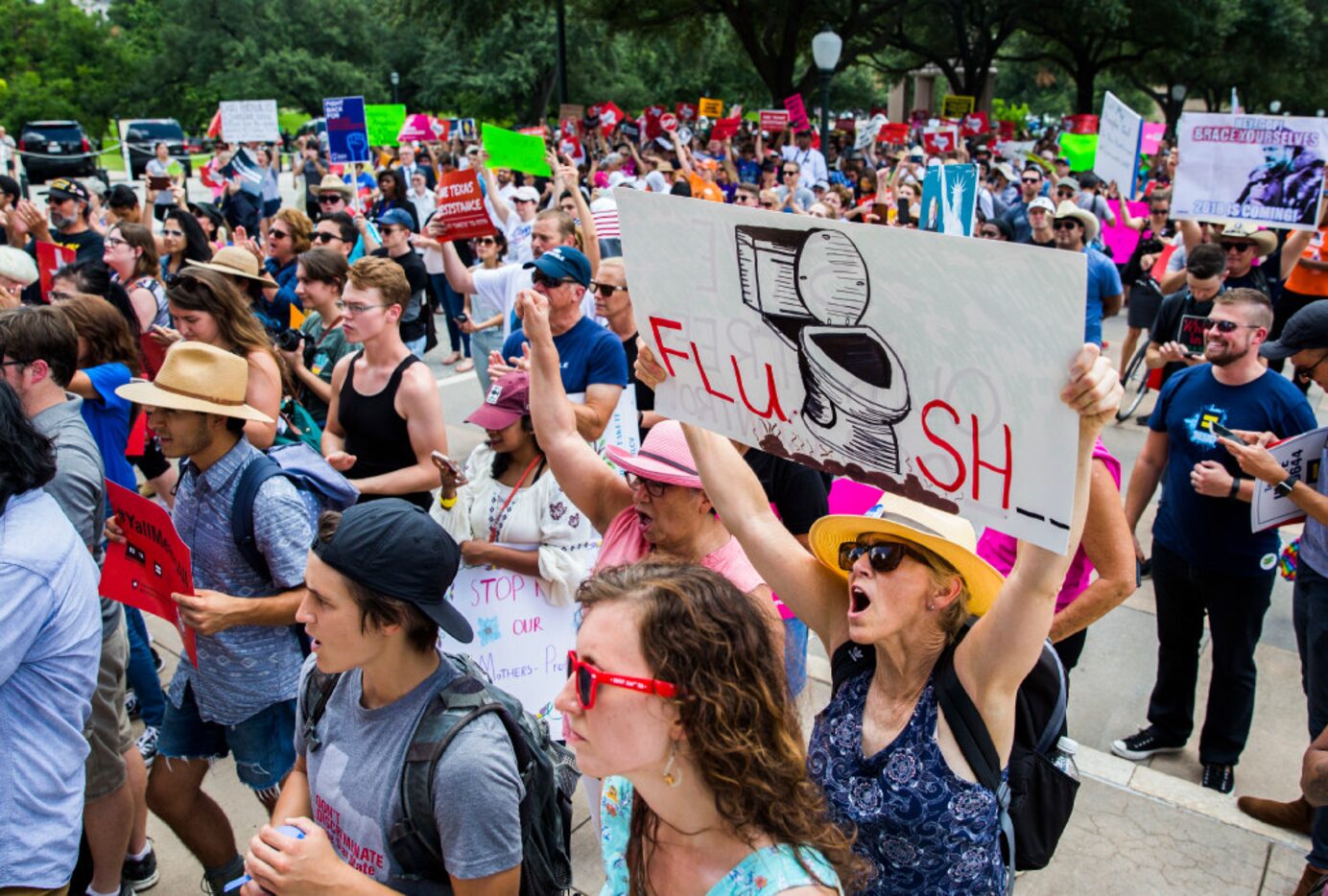 Protesters chant during a One Texas Resistance rally on the south steps of the Capitol on...