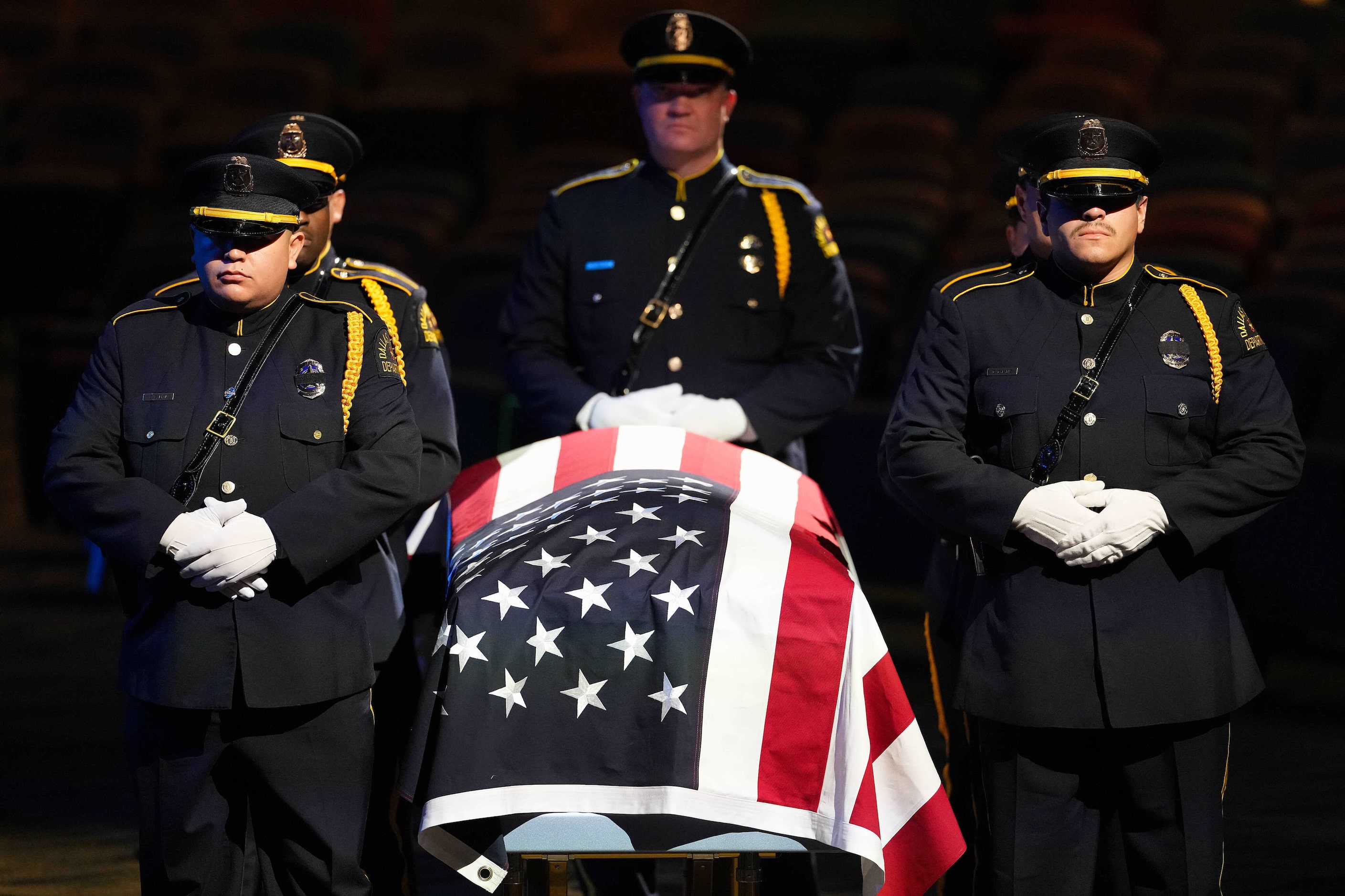 Members of the Dallas Police Honor Guard  stand at the casket of officer Darron Burks as the...