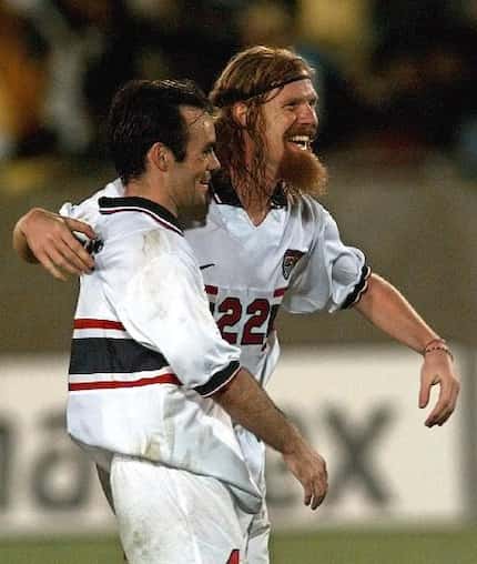 USA's Alexi Lalas, right, embraces teammate Mike Burns after defeating Brazil 1-0 in their...