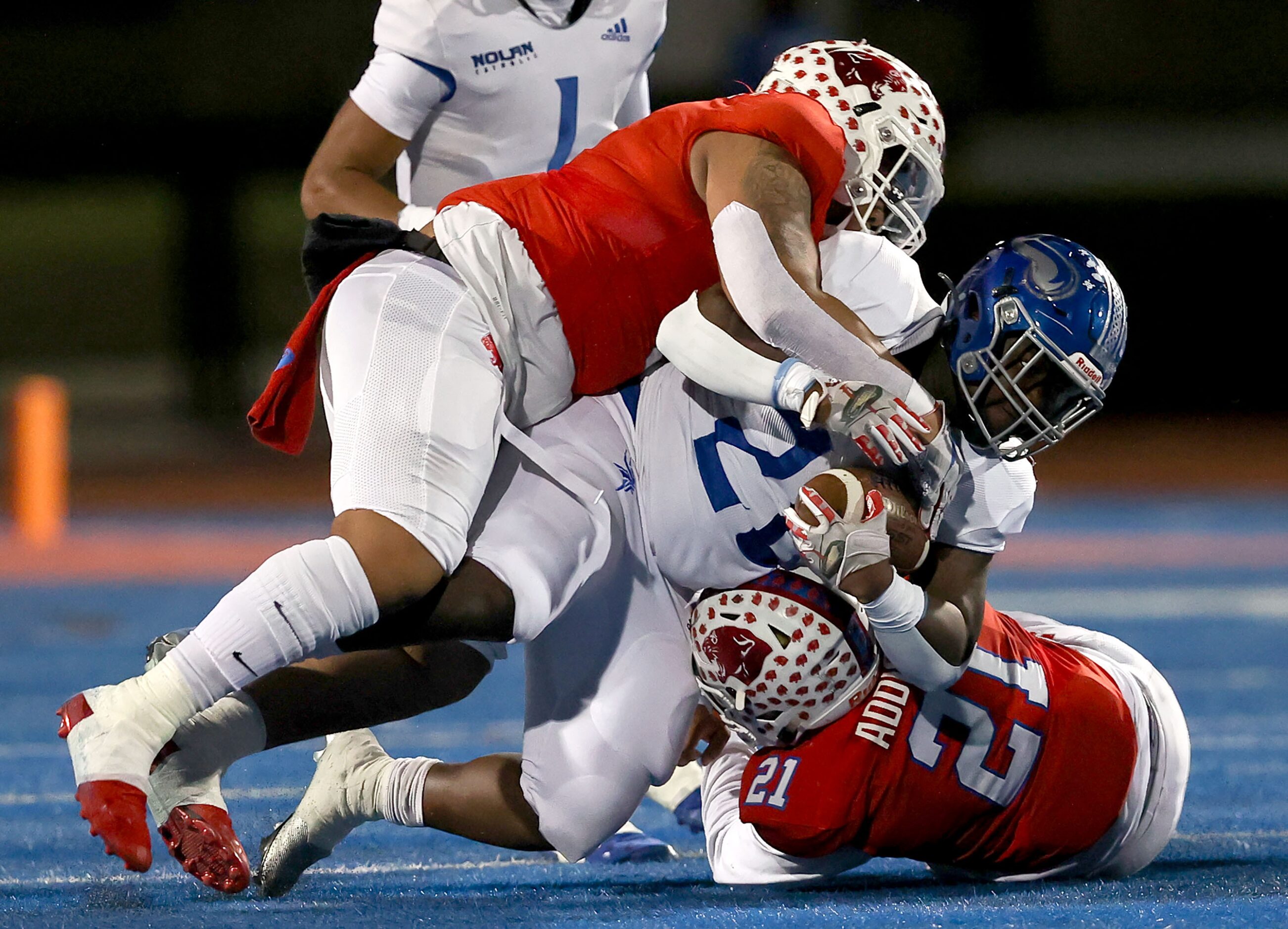 Nolan running back DK Smittick (20) gets stuffed and brought down by Parish linebacker...