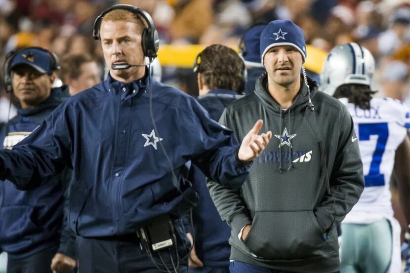 Dallas Cowboys quarterback Tony Romo paces the sidelines as head coach Jason Garrett...