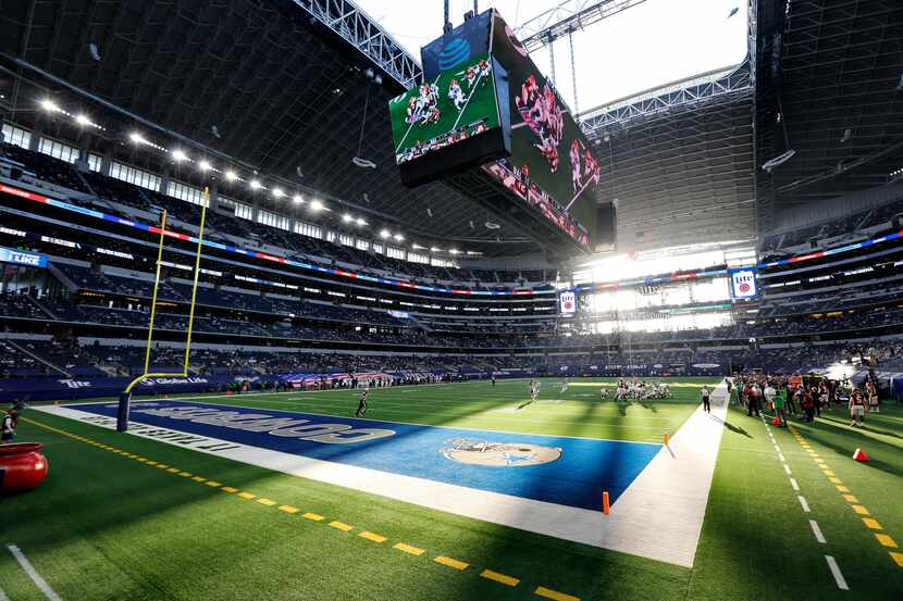 The sun shines through the open end zone doors and roof as the Dallas Cowboys faced the...