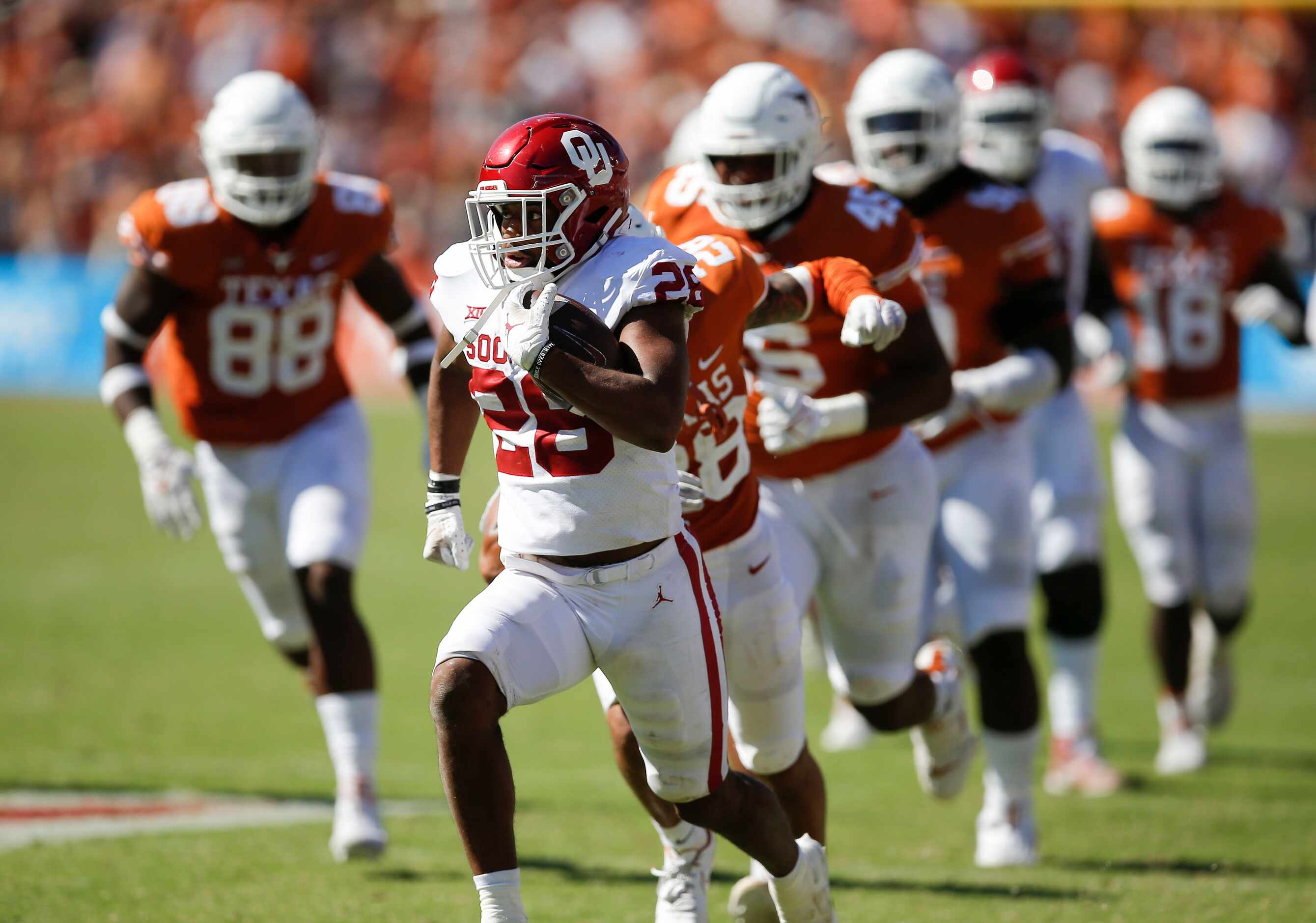 Oklahoma running back Kennedy Brooks (26) breaks past the Texas defense to score the game...