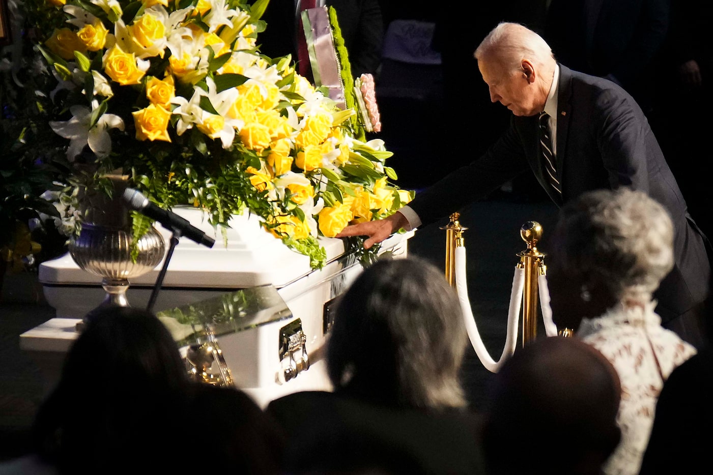 President Joe Biden reaches out to touch the casket of former U.S. Rep. Eddie Bernice...