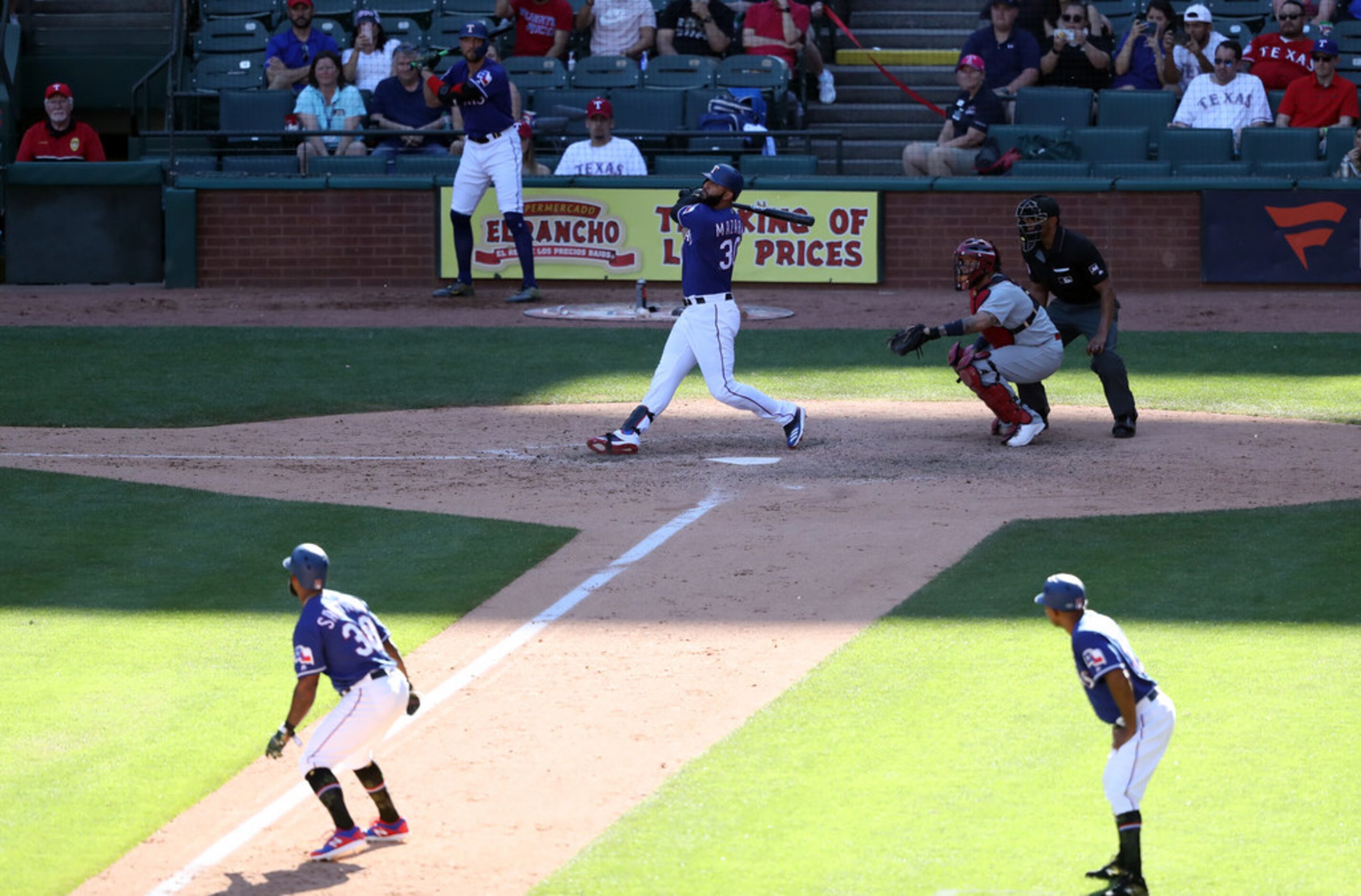 ARLINGTON, TEXAS - MAY 19: Nomar Mazara #30 of the Texas Rangers hits a sacrifice fly to...