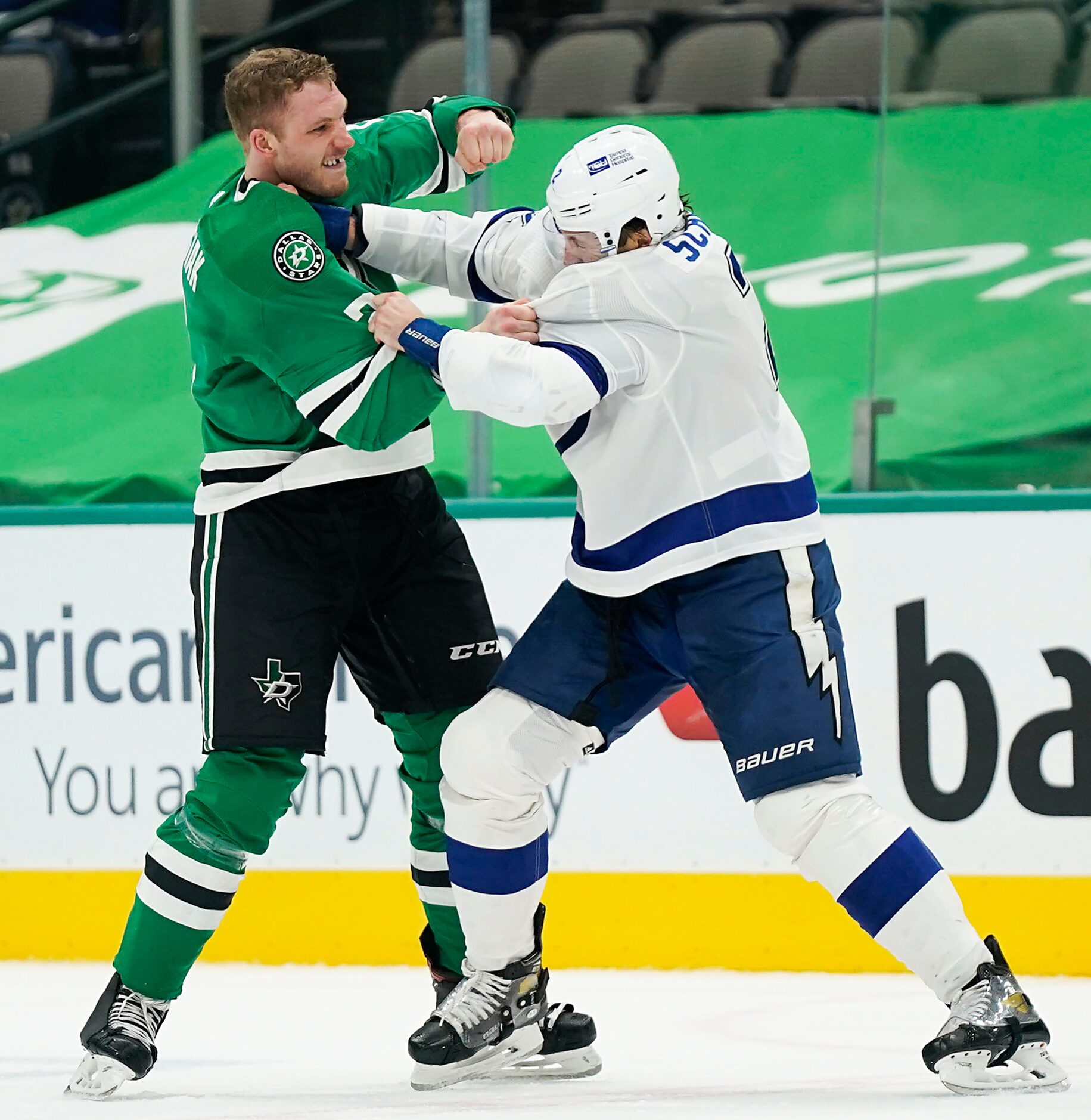 Dallas Stars defenseman Jamie Oleksiak (left) fights with Tampa Bay Lightning defenseman...