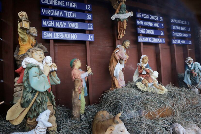 A traditional Nativity scene depicts the birth of Jesus in front of St. Susanna's Catholic...