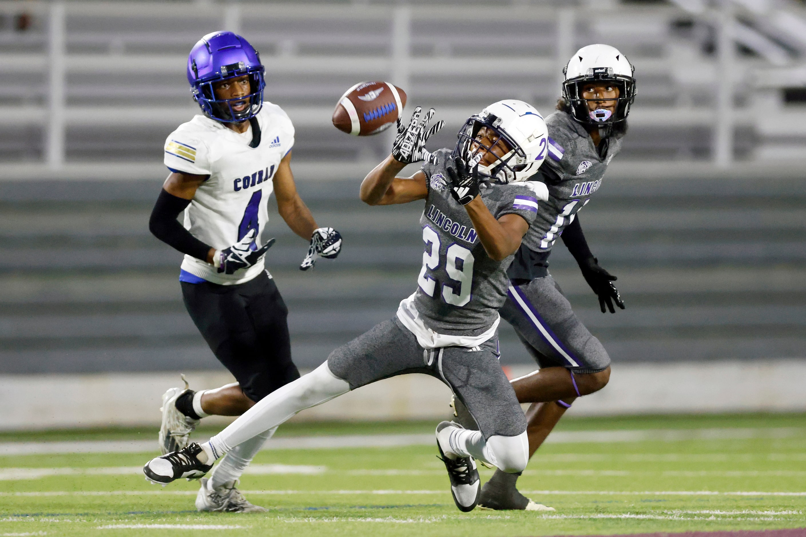 Lincoln defensive back Koron Hill (29) intercepts a pass intended for Conrad wide receiver...