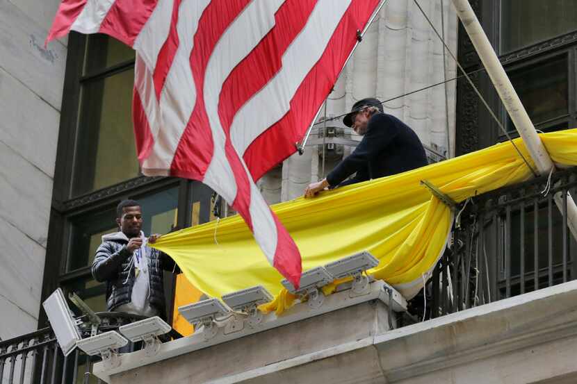 Workers prepare the banner for the Snap Inc. IPO on the facade the New York Stock Exchange,...