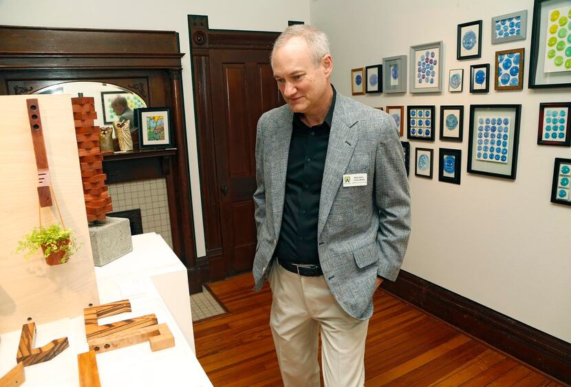 
Michael Coleman, board president for the ArtCentre of Plano, checks out an exhibit on...