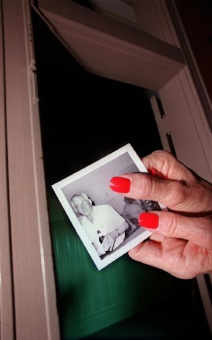 Sons of Hermann Hall manager Jo Nicodemus holds a snapshot of the Hall's former caretaker...