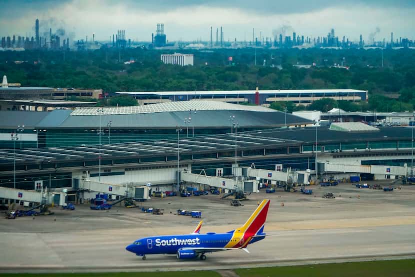 A Southwest Airlines 737-700 taxis to the terminal at Houston Hobby Airport on Friday, March...