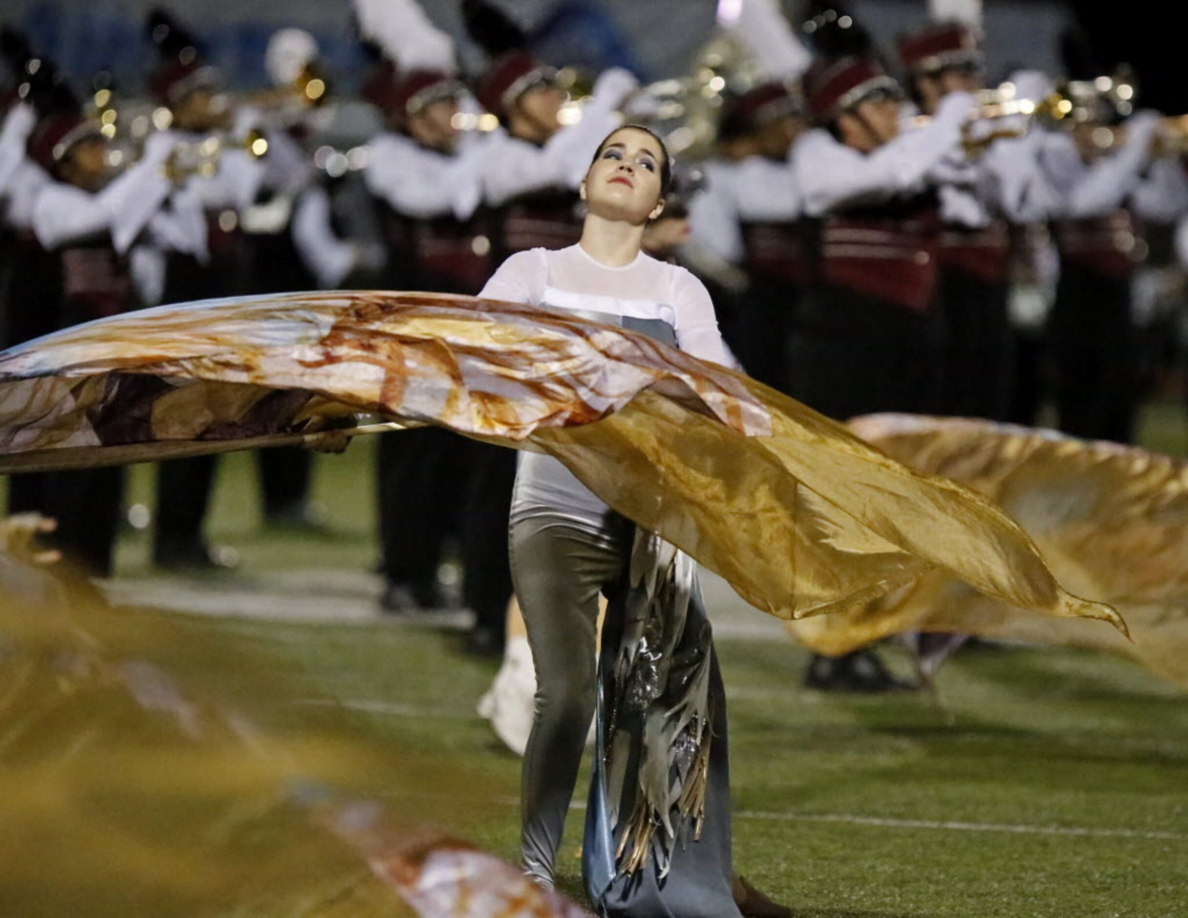 The Wylie High School Marching band played as the flag corps performed at half time as Wylie...