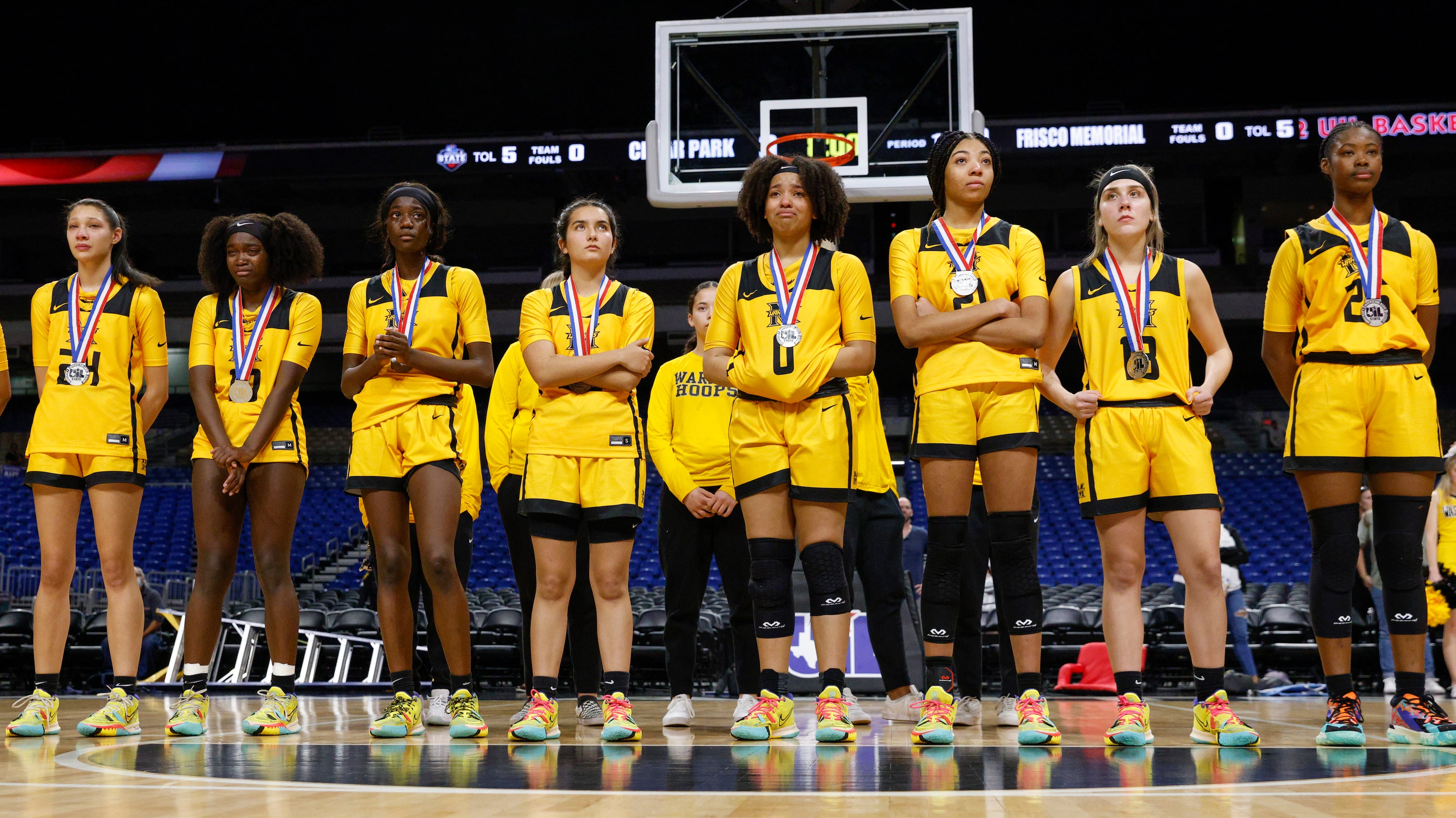 Frisco Memorial players watch as Cedar Park celebrate after winning the Class 5A state...