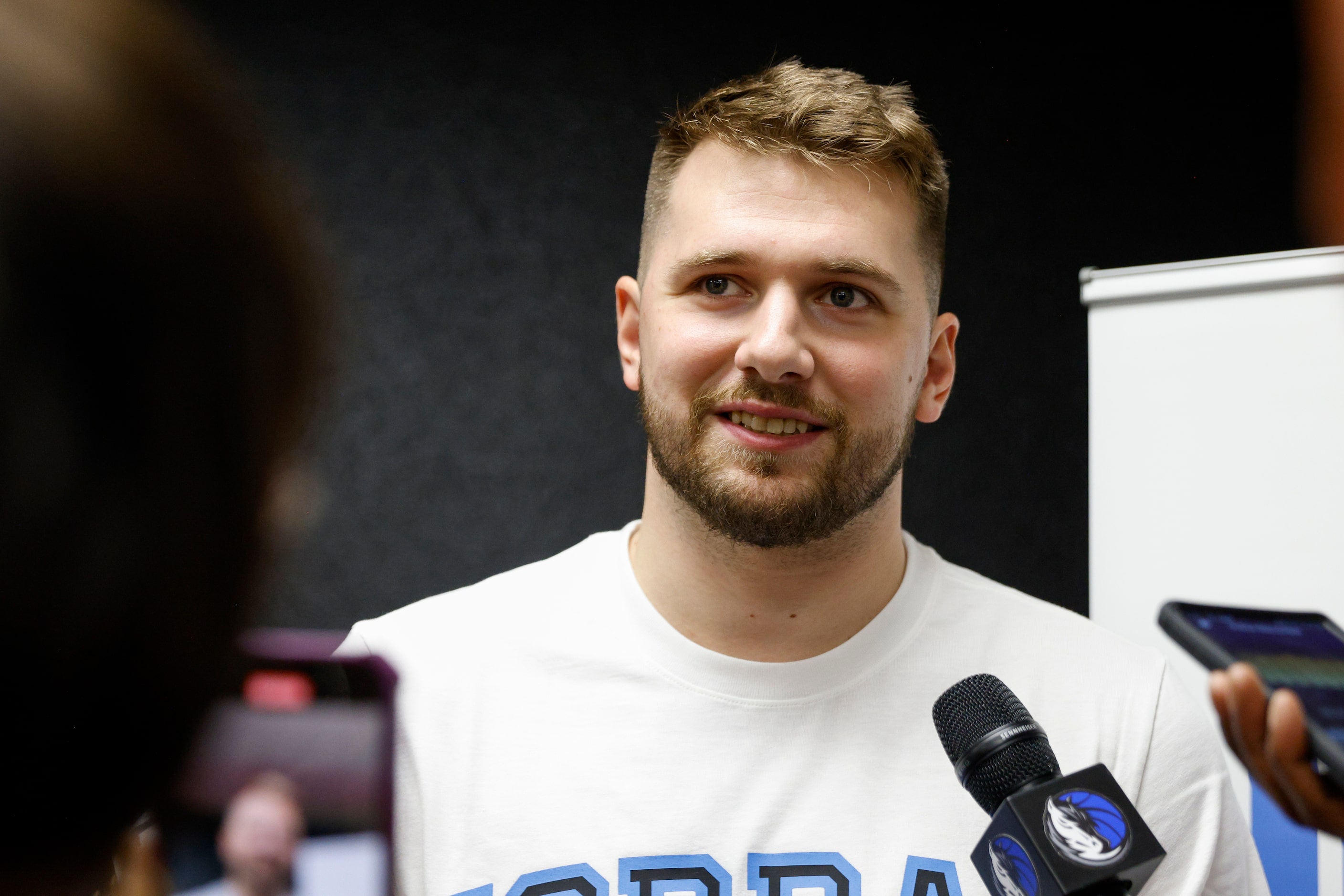 Dallas Mavericks guard Luka Doncic speaks with members of the media after a children’s...