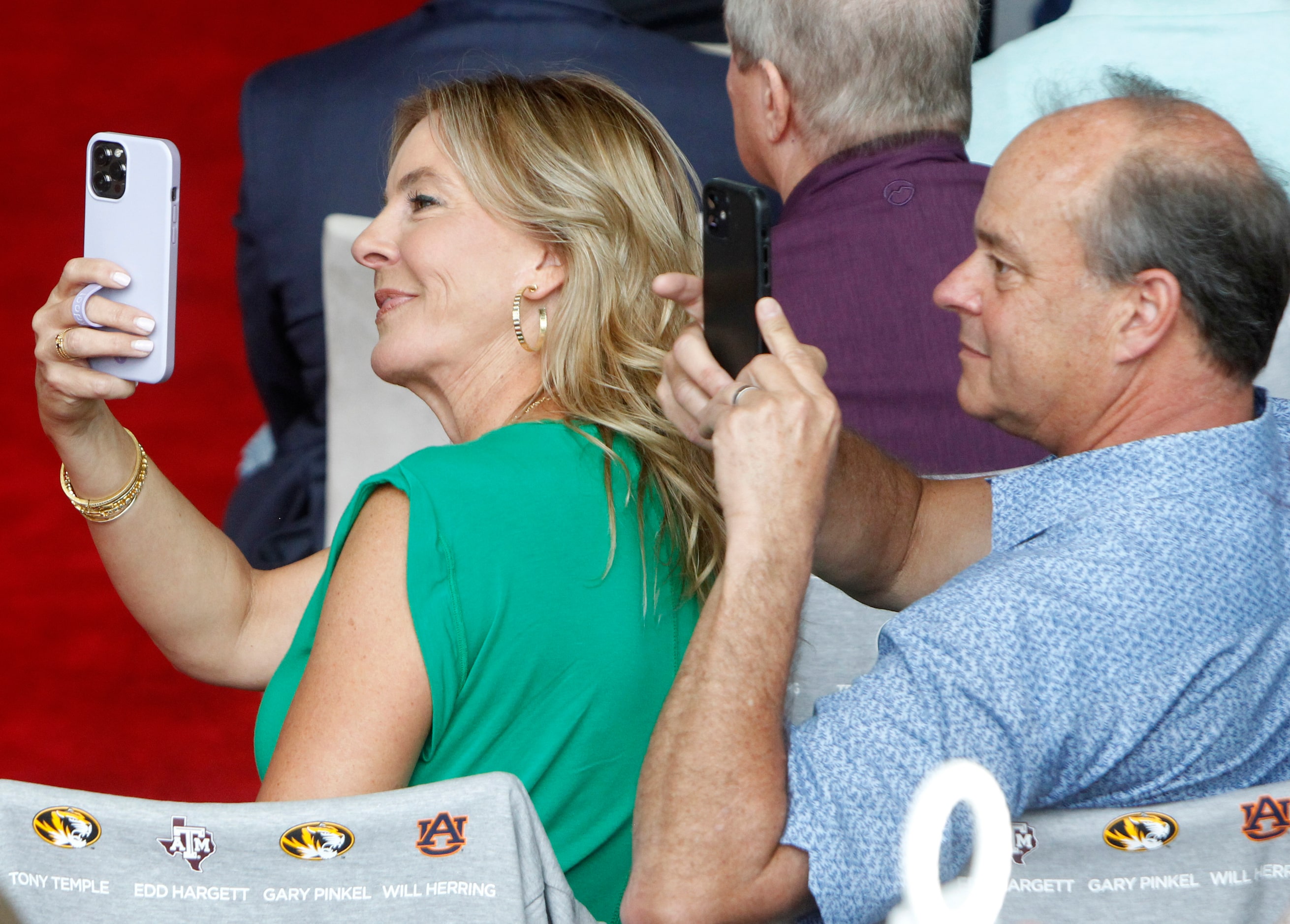 Ceremony attendees record video as the honorees are announced at the 2023 Cotton Bowl...