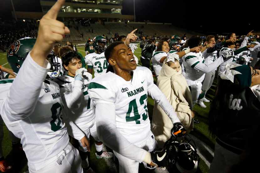 Naaman Forest players, including Nick Abengowe (43), celebrate their 42-27 win over Lakeview...