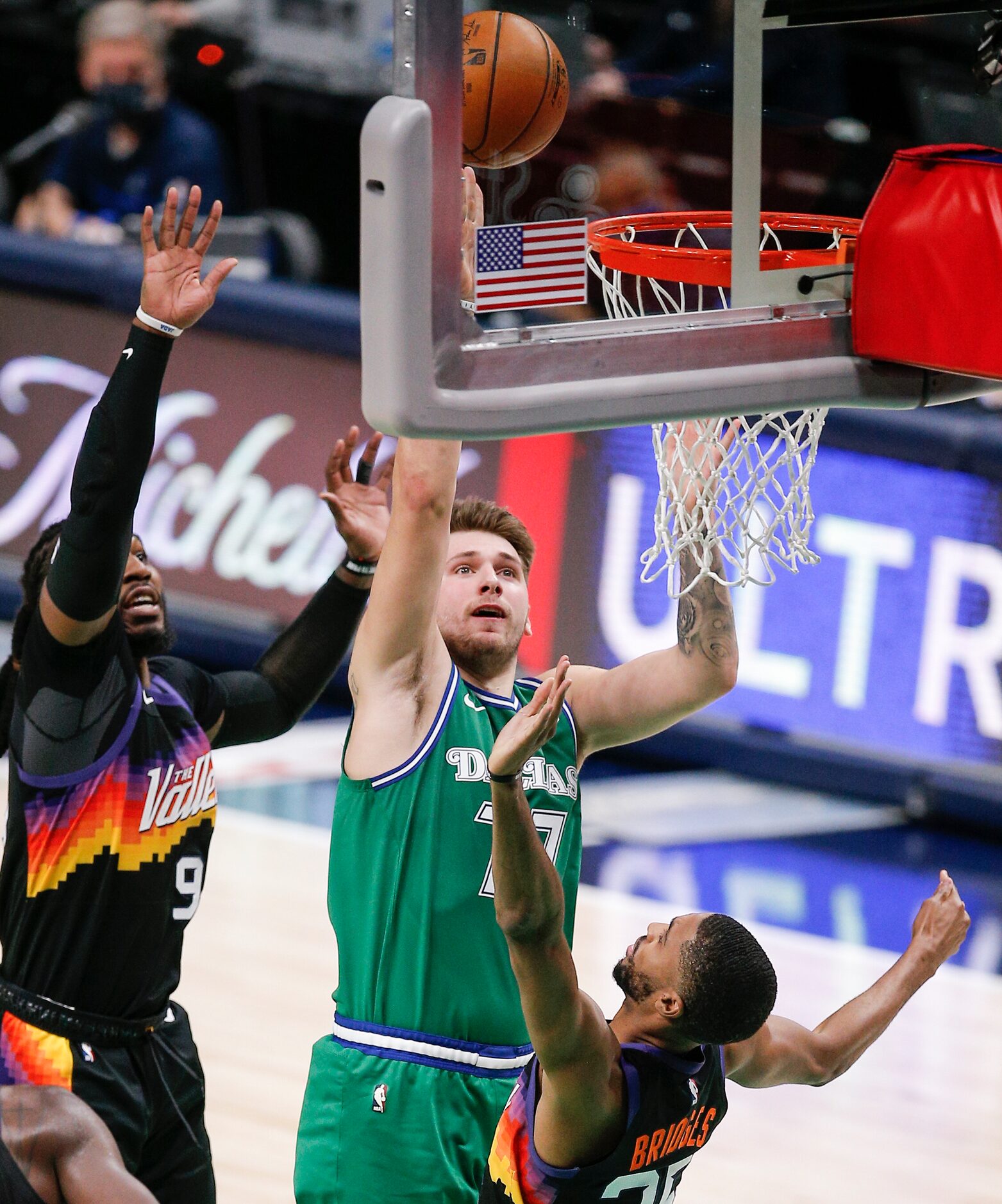 Dallas Mavericks guard Luka Doncic (77) attempts a shot as Phoenix Suns forwards Jae Crowder...