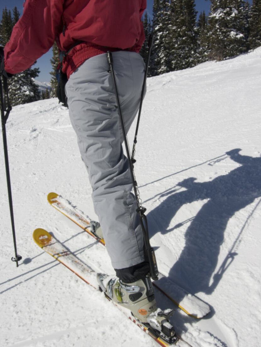 Through the use of a spring-loaded rod, CADS move upper body weight directly to the ski...