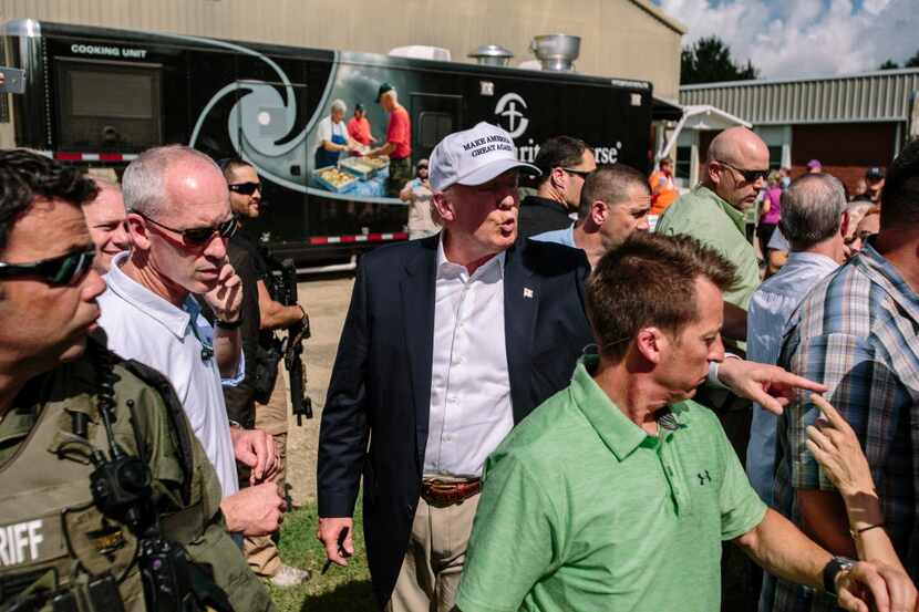 Republican nominee Donald Trump greets supporters during a disaster relief event with...