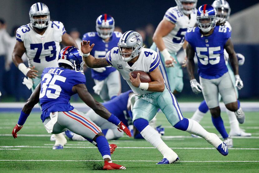 Dallas Cowboys quarterback Dak Prescott (4) take off running with the ball on a keeper...
