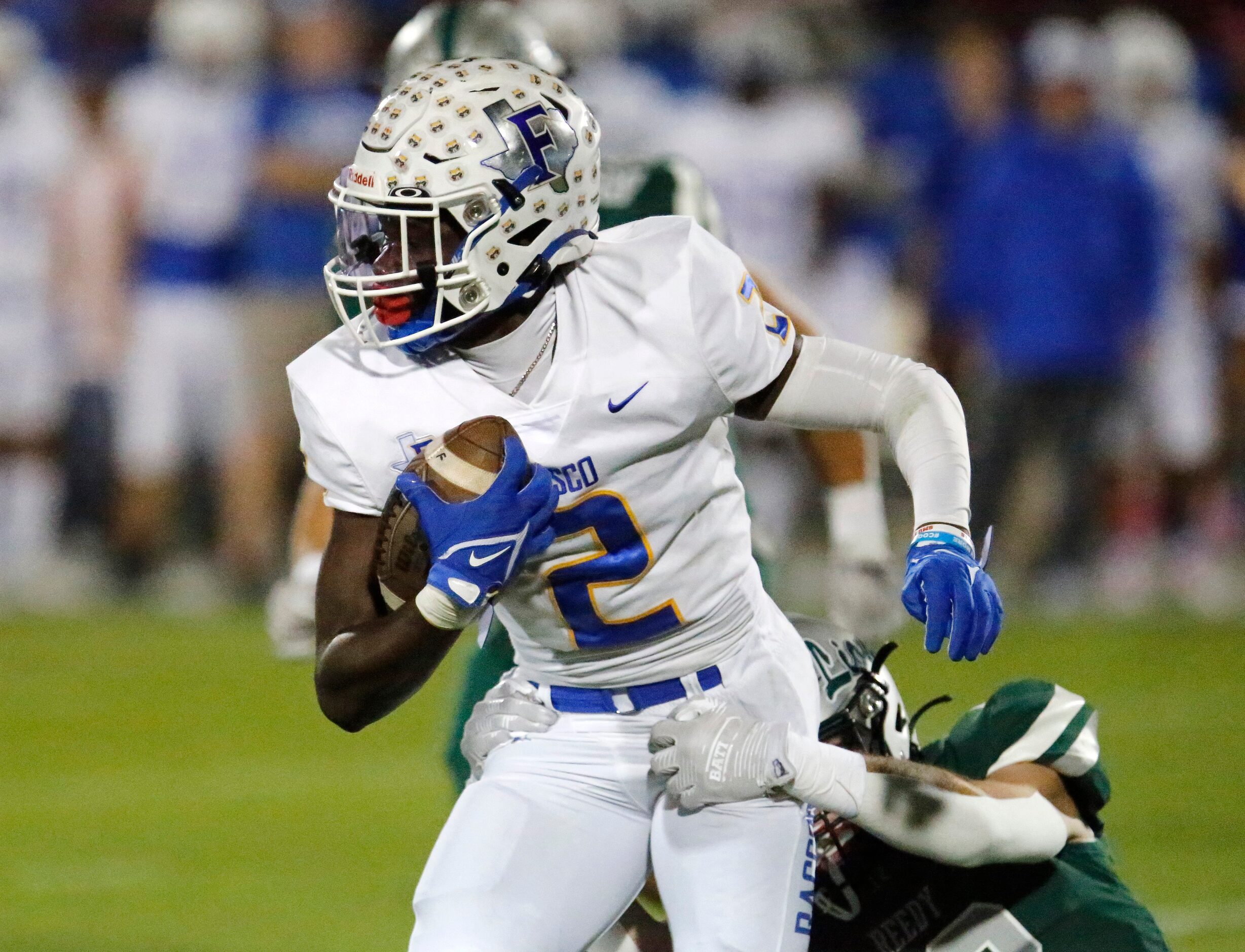 Frisco High School wide receiver Ismael Taylor (2) is slowed down by Reedy High School...