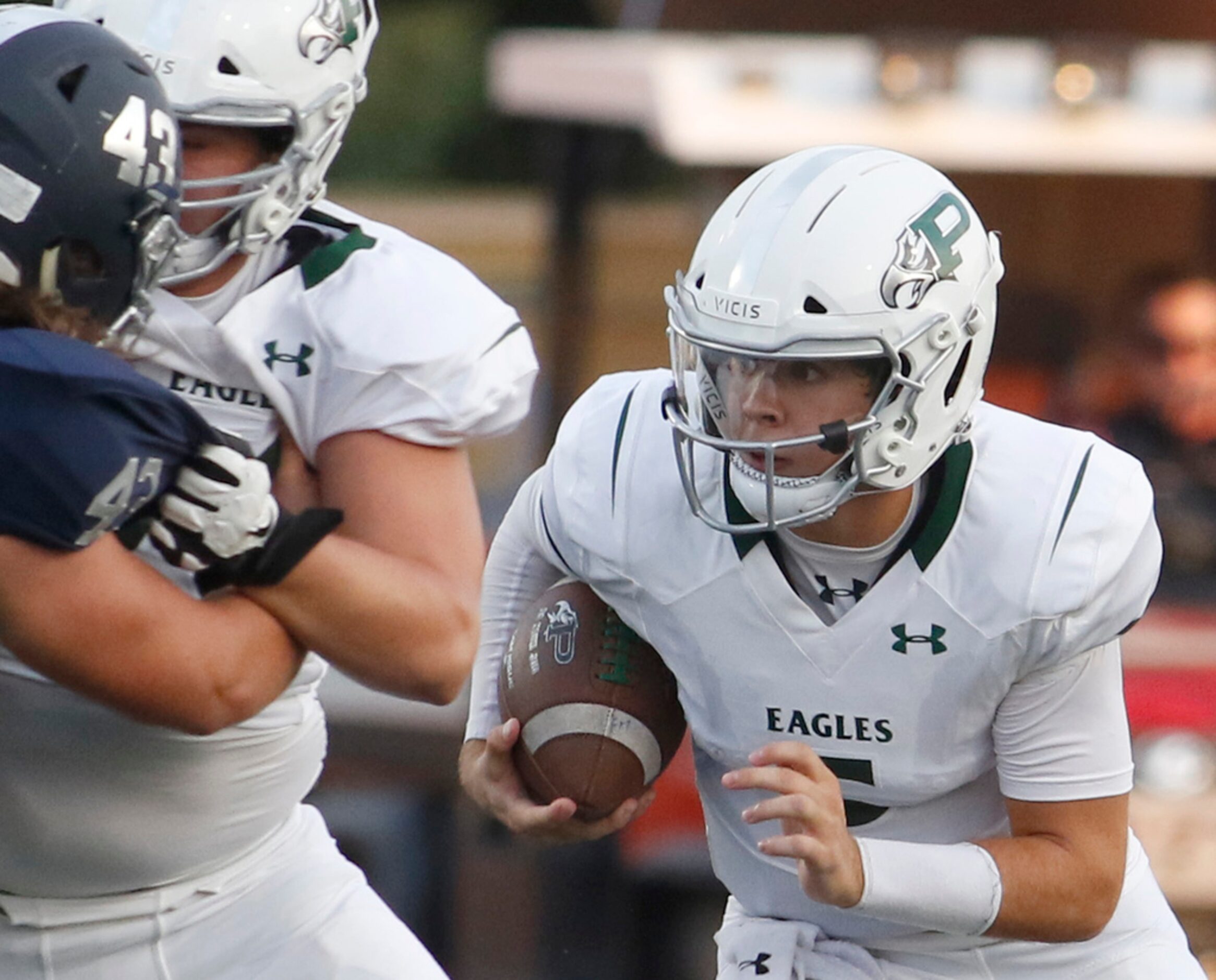 Prosper quarterback Jackson Berry (5) utilizes a block by an offensive lineman as he takes...