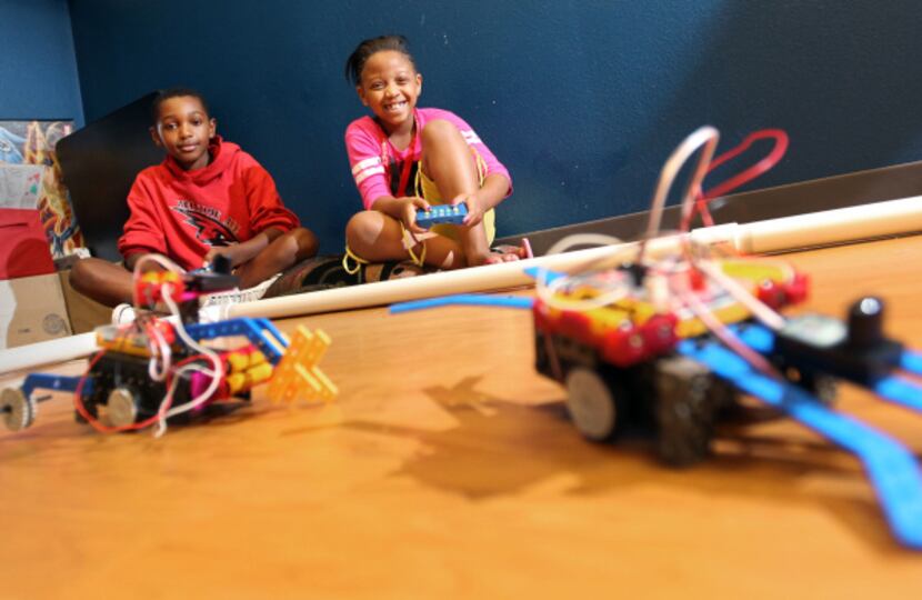 Felix Reeves, 10, and Maya Mcintyre, 9, were happy campers as they raced the robots they...