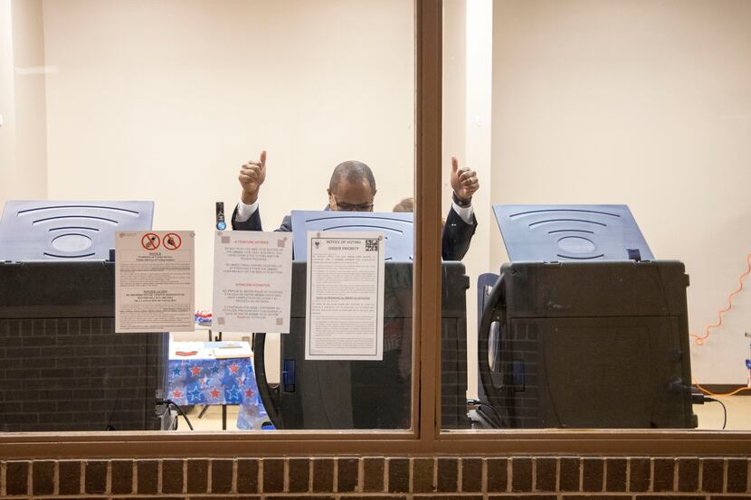 Eric Johnson raised two thumbs up after casting his vote at Samuell Grand Recreation Center...
