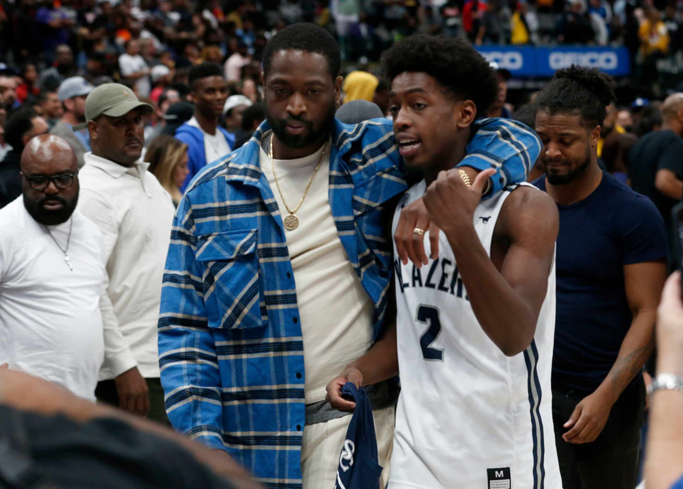 Dwyane Wade walks off the court with his son Zaire Wade after Sierra Canyon defeated...