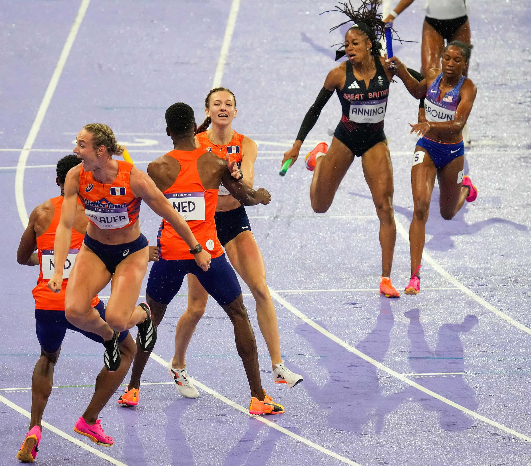 Femke Bol of the Netherlands (facing) celebrates with teammates after winning the...