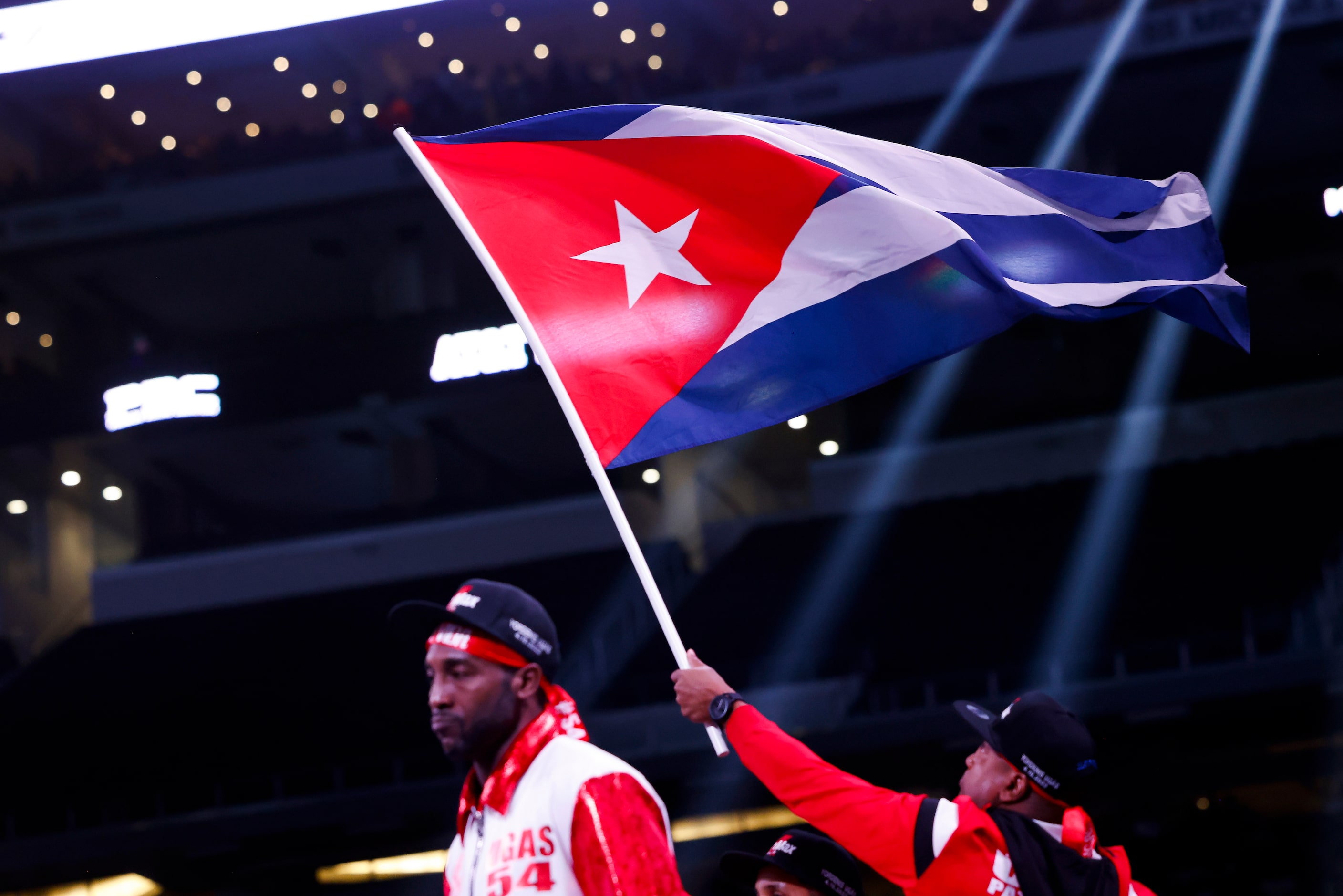 A cuban flag flies as Yordenis Uga walks to the ring before welterweight championship boxing...