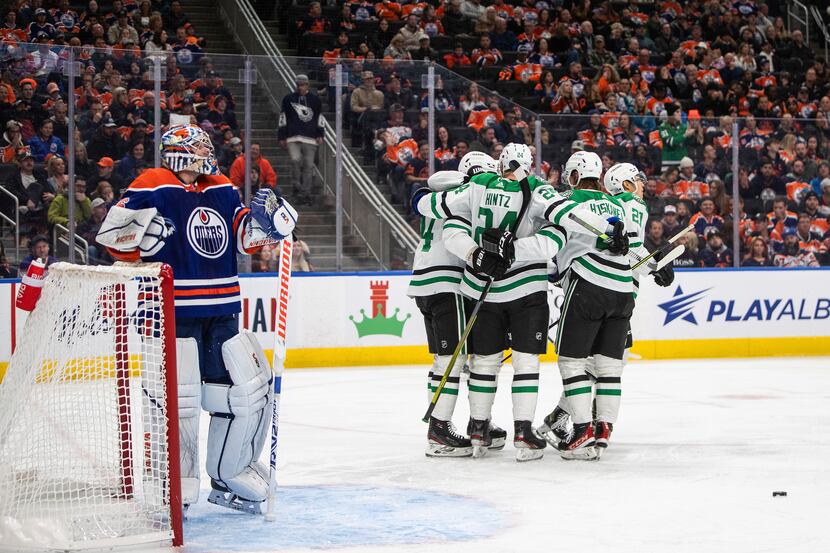 Dallas Stars players celebrate after a goal against Edmonton Oilers goalie Jack Campbell,...