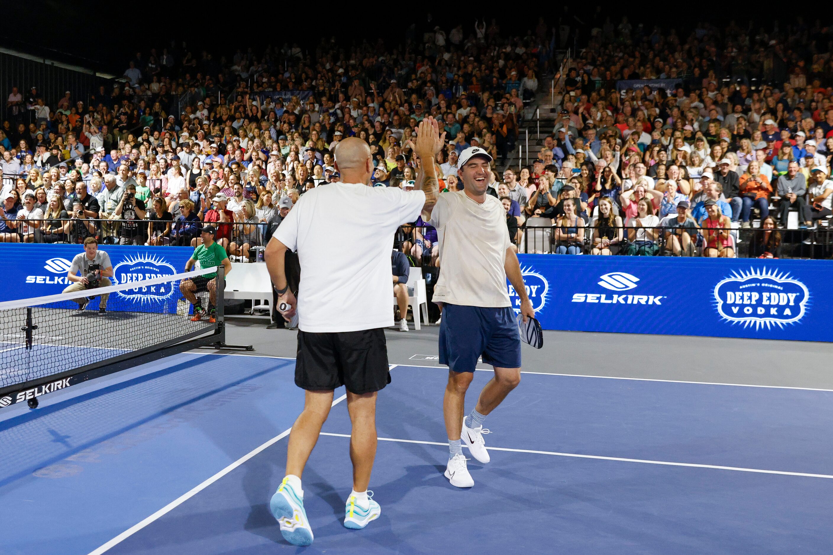 Dallas Mavericks head coach Jason Kidd (left) high fives Pro golfer Scottie Scheffler after...