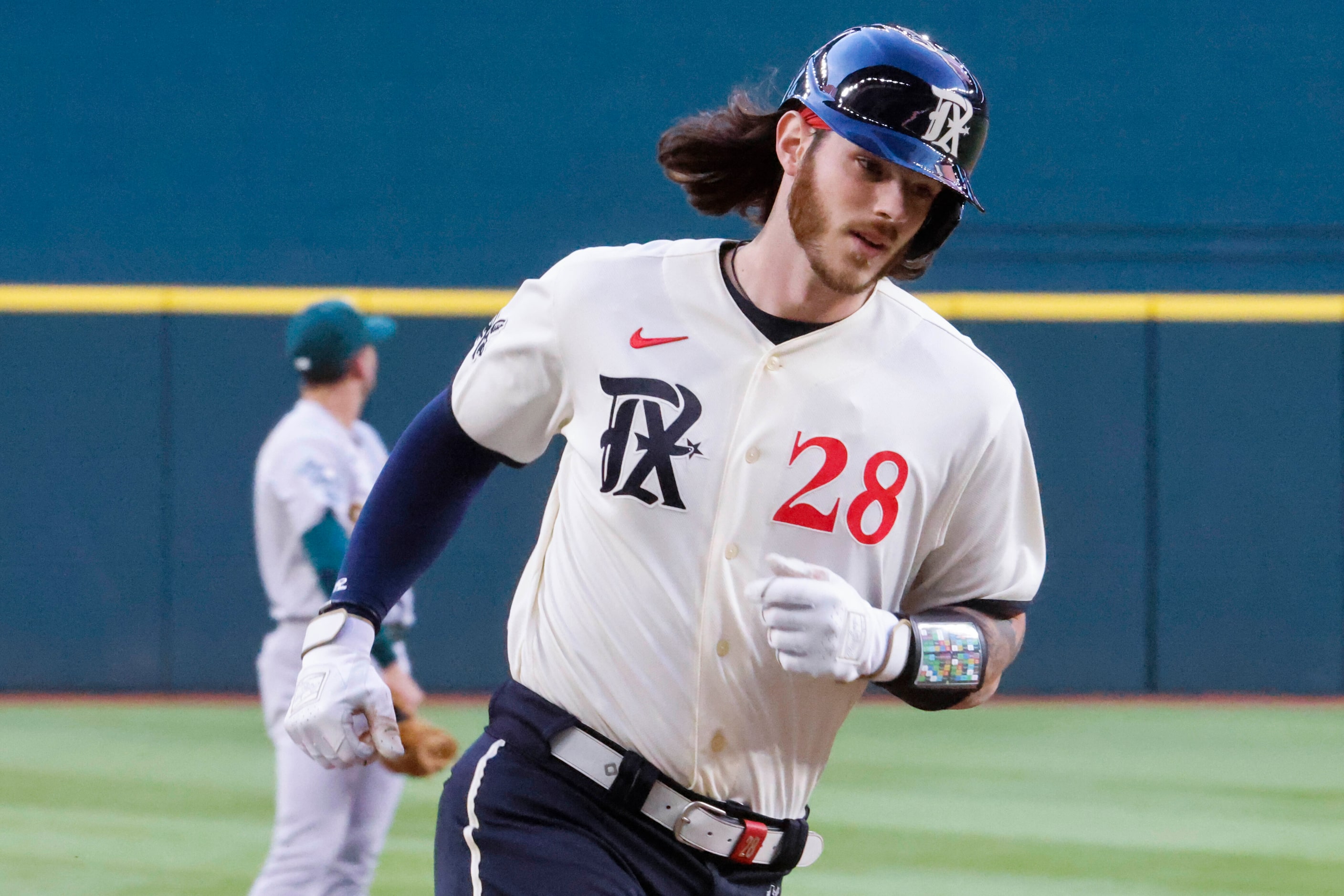 Texas Rangers catcher Jonah Heim runs between bases after a homer during the first inning of...