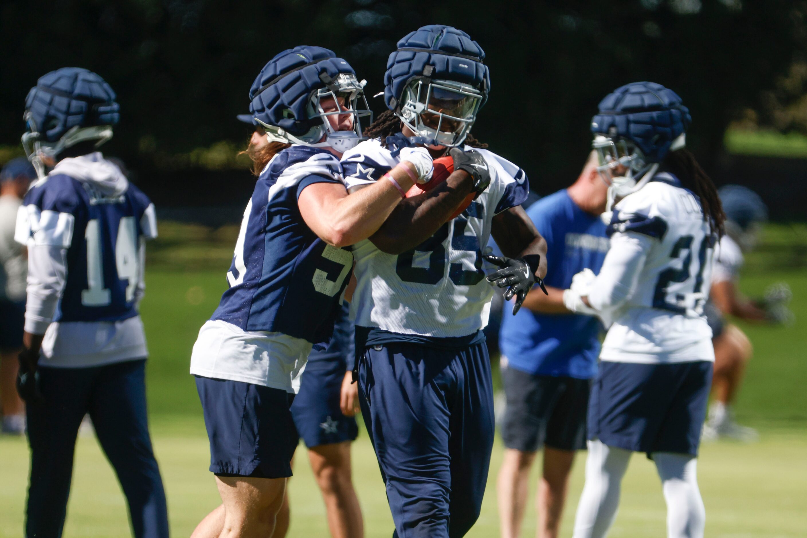 Dallas Cowboys linebacker Brock Mogensen (left) battles against Dallas Cowboys tight end...