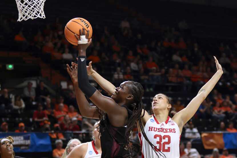 Texas A&M guard Aicha Coulibaly, left, drives to the basket as Nebraska guard Kendall Coley,...