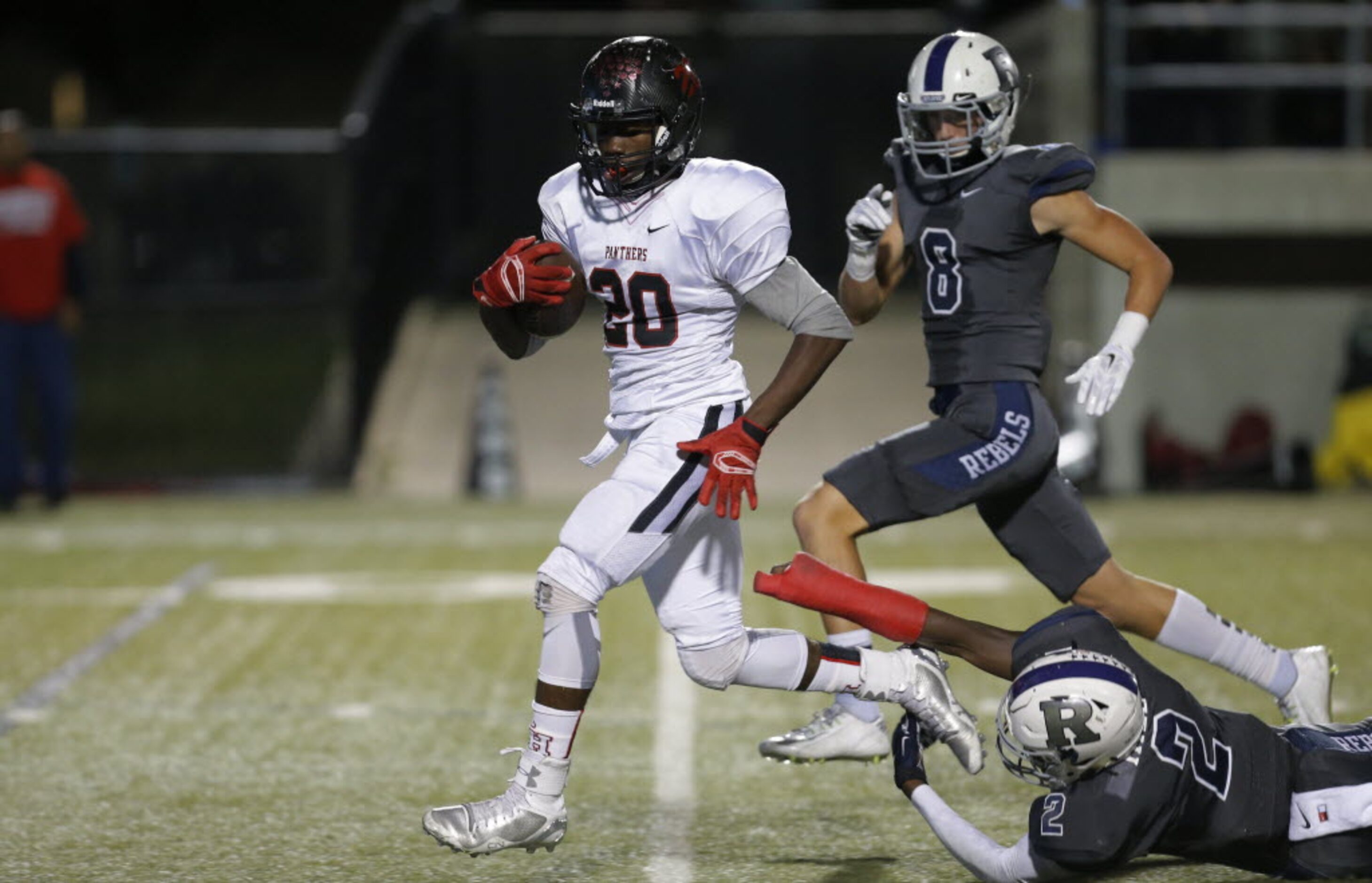 Colleyville Heritage sophomore wide receiver Ke'von Ahmad (20) out runs Richland's PJ Hill...