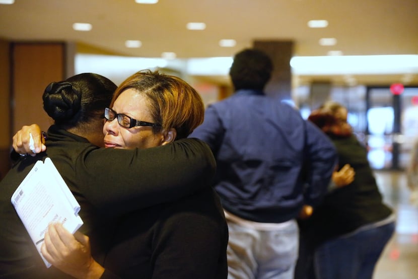 Sheritha Smith, Toya Smith's sister, hugs a relative of Zina Williams Bowser after Erbie Lee...