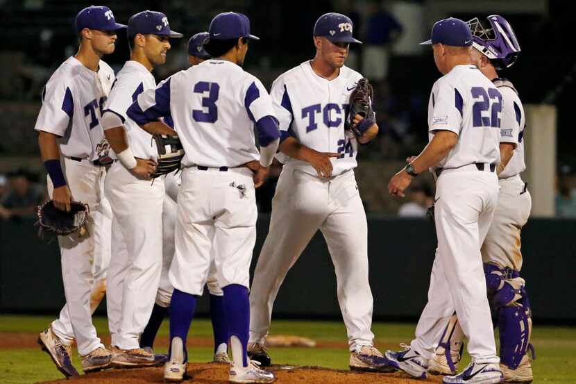 Head coach Jim Schlossnagle (22) talks on the mound to TCU pitcher Jake Eissler (24) during...