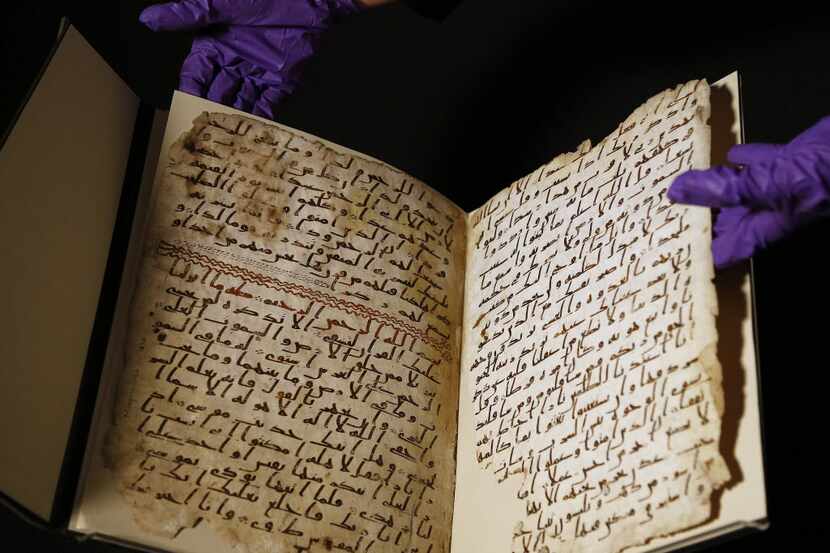 A university assistant shows fragments of an old Quran at the University in Birmingham, in...