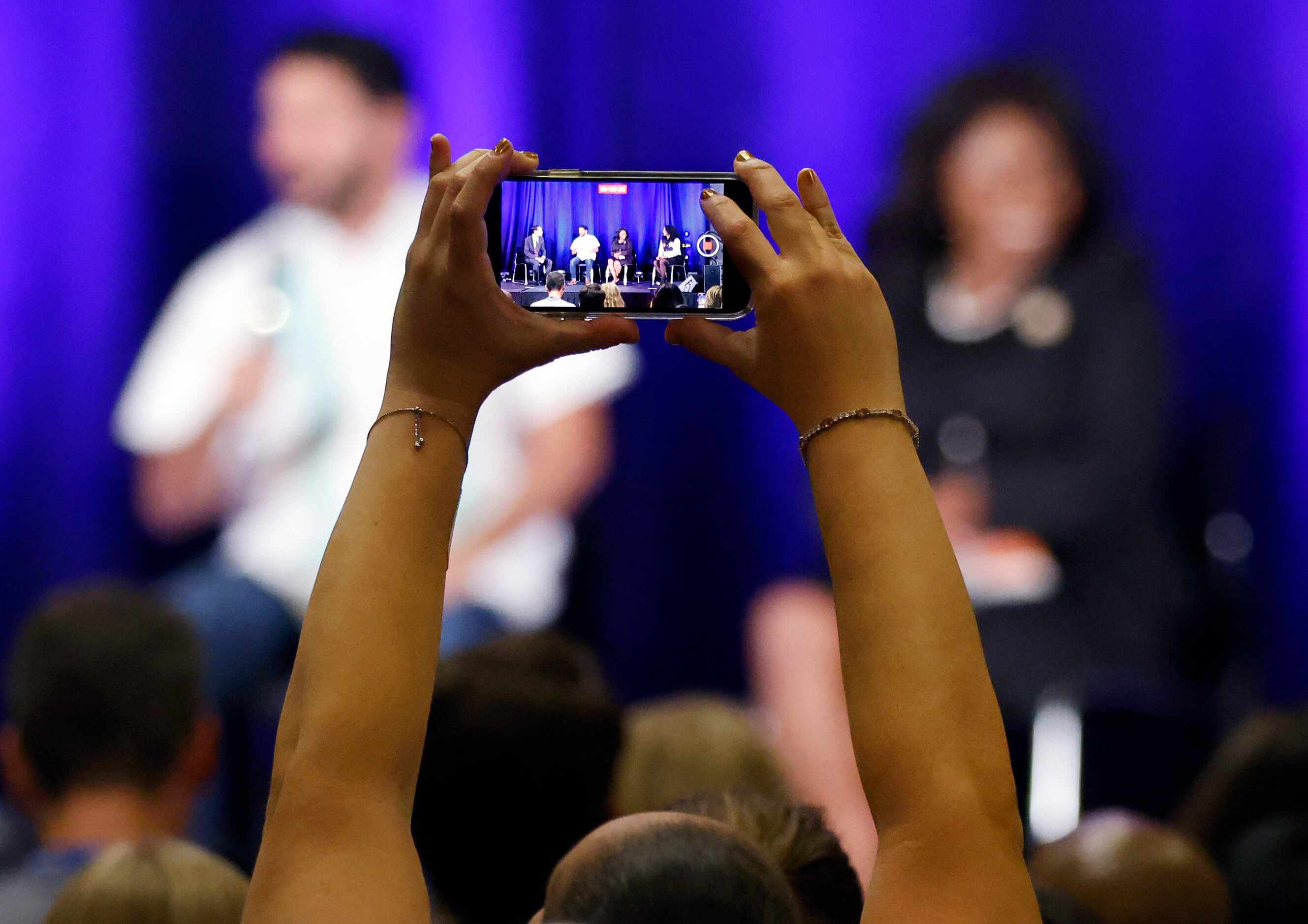A delegate records a video of U.S. House Texas District candidates on a panel discussion at...