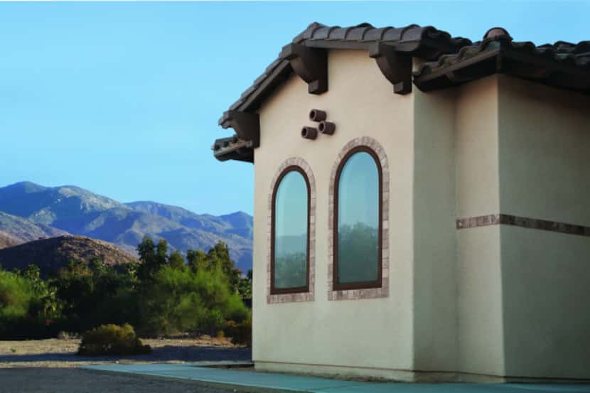 The 100 Series Springline specialty fixed window, shown in exterior color Cocoa Bean, has an...