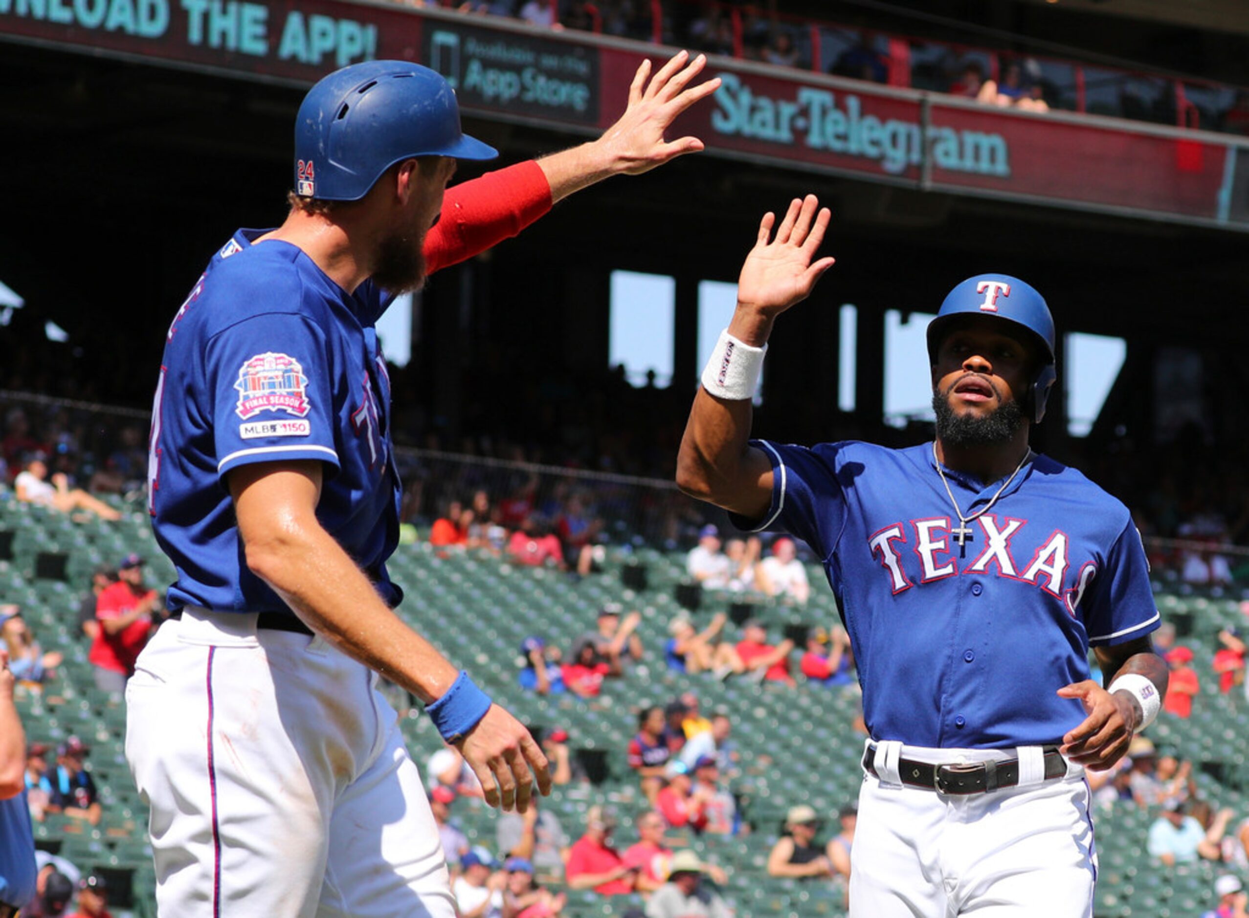 Texas Rangers' Hunter Pence (24) greets Delino DeShields (3) after they scored on a single...