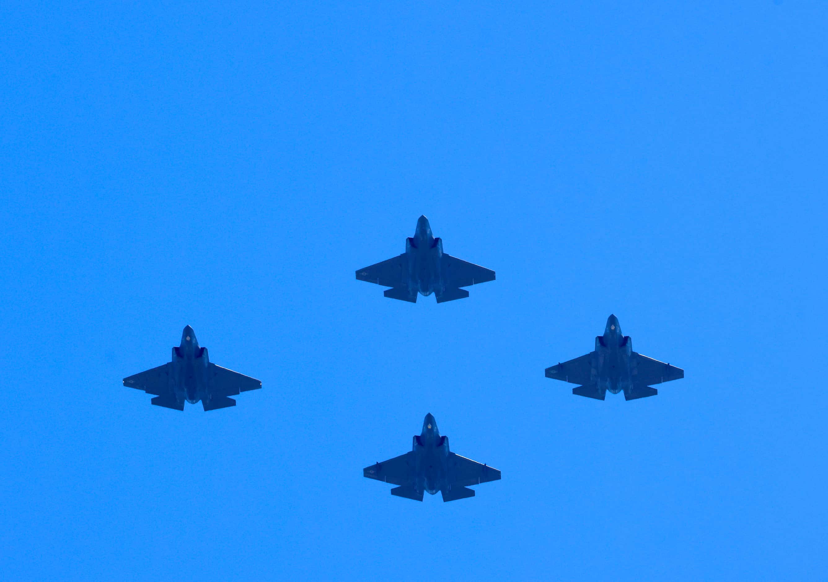 Four F-35 military aircraft perform a flyover of the Dallas Cowboys training camp fields in...
