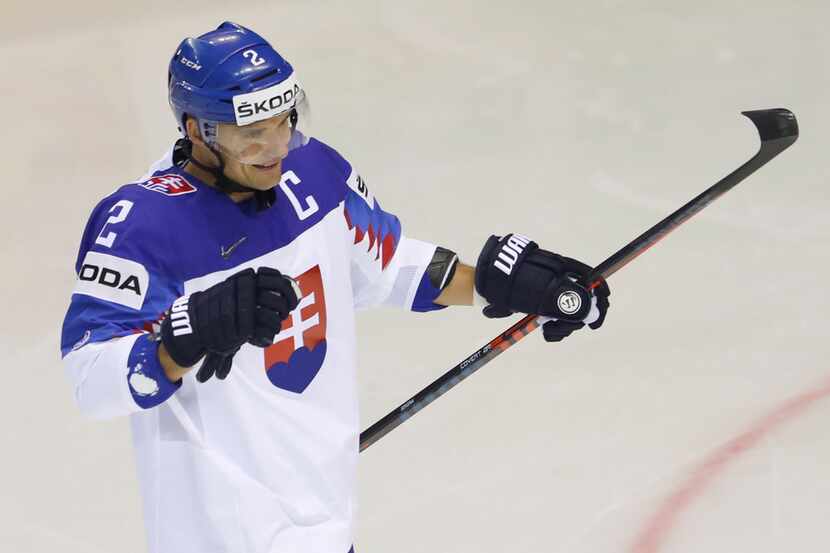 Slovakia's Andrej Sekera celebrates after scoring his sides first goal during the Ice Hockey...