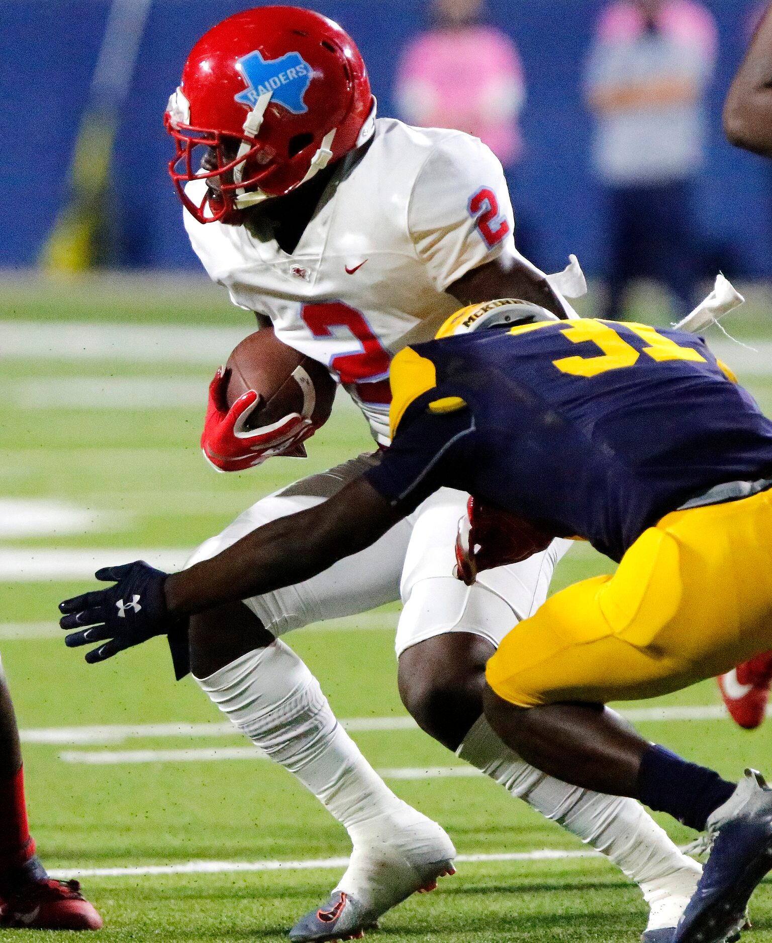 Skyline High School wide receiver Quaydaruis Davis (2) is met by McKinney High School...