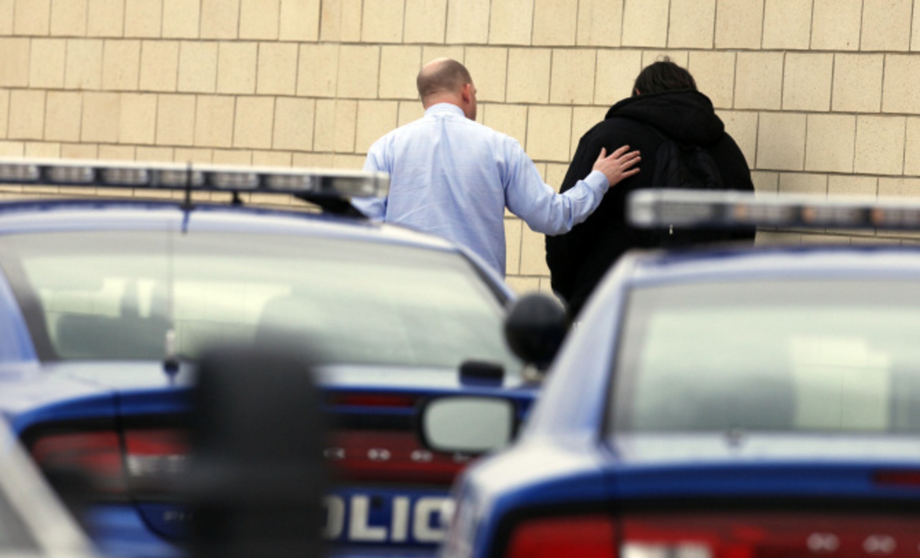 An administrator counsels a student after a lockdown at Arlington Lamar High School due to a...