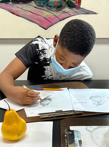 Corban Brookins, 11, takes part in an art class at Pencil on Paper Gallery.